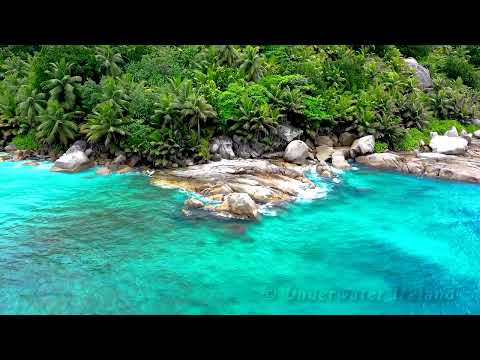 Sound of waves rolling over the rocky tropical coast with blue water for deep sleep, relaxation yoga