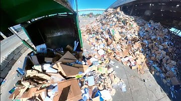 Garbage trucks dumping at transfer station. waste management