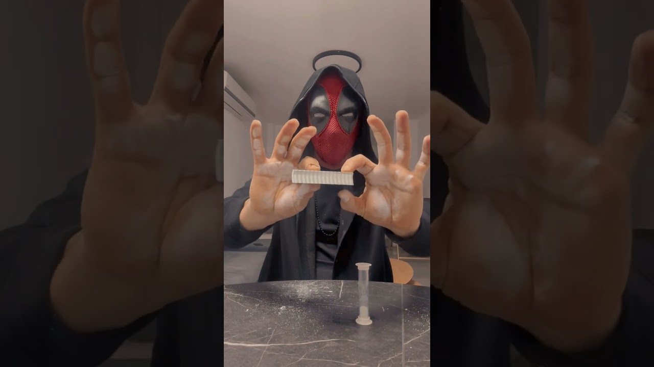 Masked Performer Demonstrates Strength with Playing Cards
