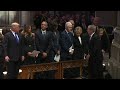 George w bush hands michelle obama a piece of candy at funeral for george hw bush