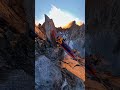 Guy sleeping in a hammock attached between two majestic ridges at 3000m