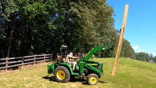 Two geezers installing 8x8 treated posts for equipment shed
