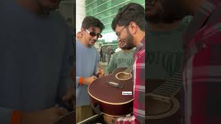 Darshan Raval signs a fan's guitar, creating a special moment💞 #darshanraval #youtubeshorts