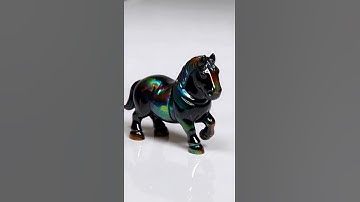 Iridescent obsidian shaped like a chess knight