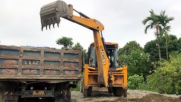 Backhoe Loader Loading Gravel In Tripper Dump Village Area