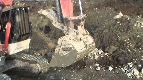 Link Belt 290 X2 roadbuilder excavator cleaning up a quarry