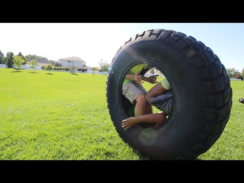 ROLLING DOWN A HILL IN A GIANT TIRE 