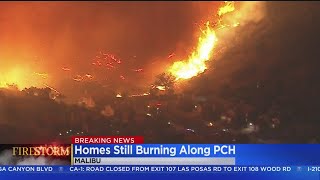 Homes along pacific coast highway continued to burn saturday morning
as the massive woolsey fire raced toward ocean, prompting a portion of
m...