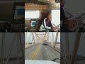 Truck driver crashes and dangles from bridge