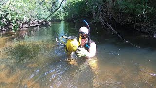 Searching for treasures in the Grand River in Jackson, Michigan