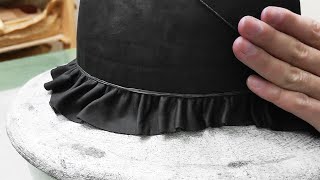 Making the crown of a leather bowler hat. Making the crown of a leather bowler hat.