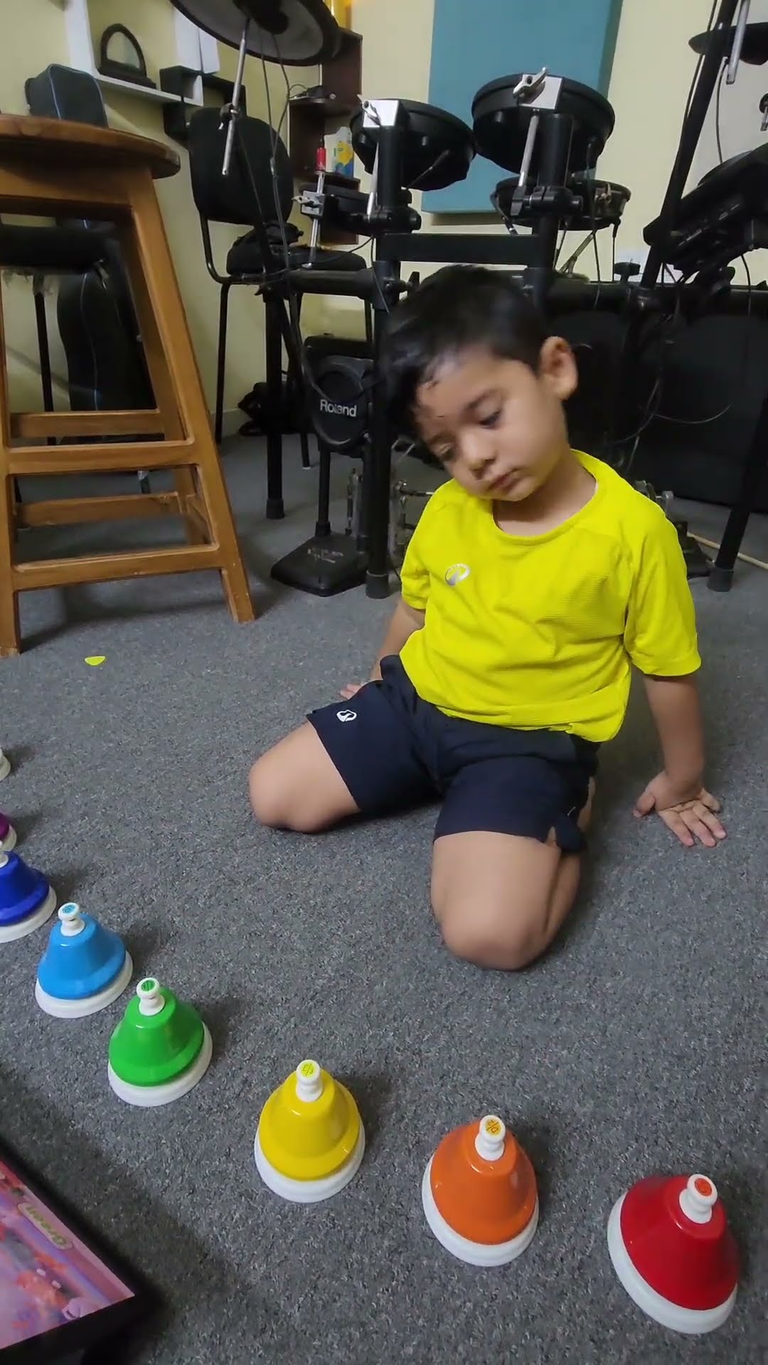 Agastya playing the Colour Song on colourful desk bells