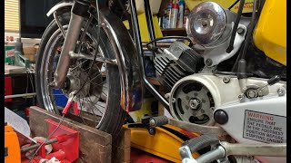 Checking ignition timing on moped engine.