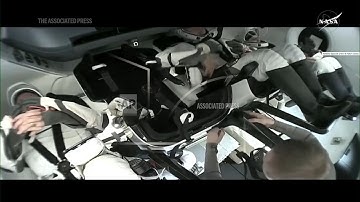 Stranded astronauts board SpaceX capsule for return to Earth