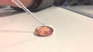 103 drops of water on a penny!