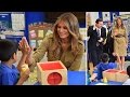 Smiling Melania shares a high five with a young pupil during a visit to a school in Saudi Arabian