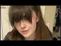 Very Pretty Brunette Woman with Long Bangs and Ponytail Wearing a Windbreaker Coat Fan Wind Blowing