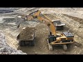 Caterpillar 385C Excavator Loading Cat Dumpers