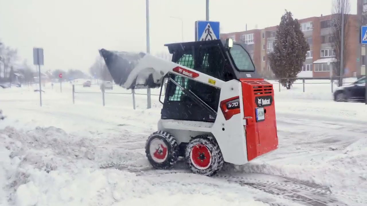 Snow Removal in Ginkūnai, Lithuania: Bobcat S70 Clearing Village Center During Blizzard