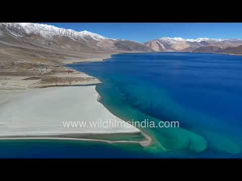 Pangong Lake in stunning aquamarine, as seen from the air in Ladakh, with high mountains behind