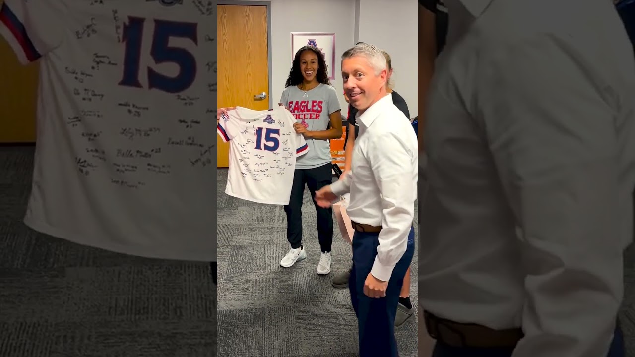 Women's Soccer Gifts Jersey to AU Director of Athletics JM Caparro