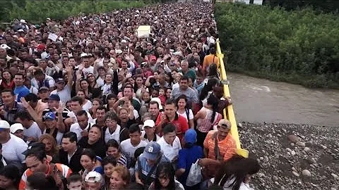 Qual foi a principal motivação que levou os venezuelanos a deixarem seu país e seguirem para o Brasil?