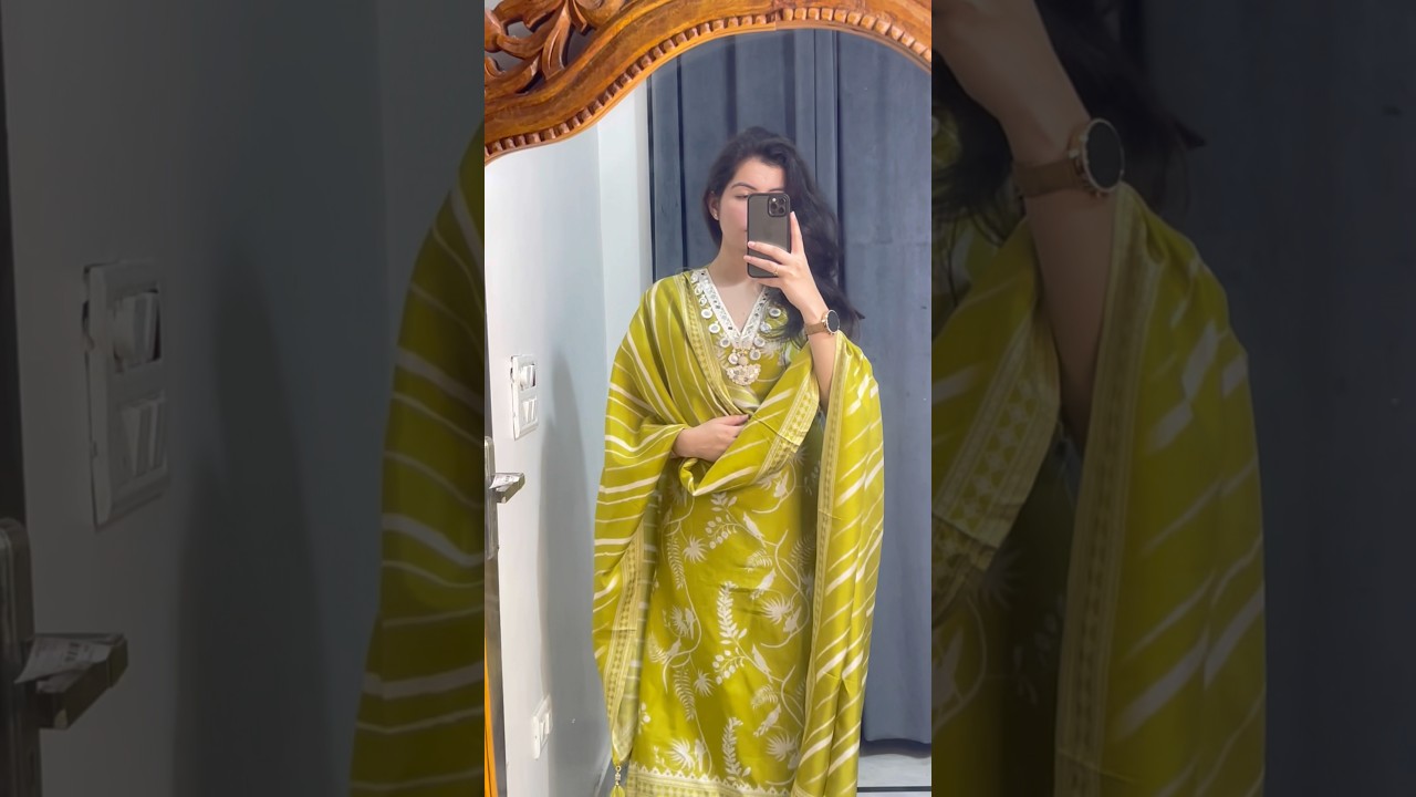 A bright green suit with white floral prints 🌿styled with a striped dupatta and mirrorwork neckline