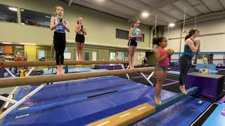 Gold and Platinum Gymnasts Getting Warmed Up for Balance Beam