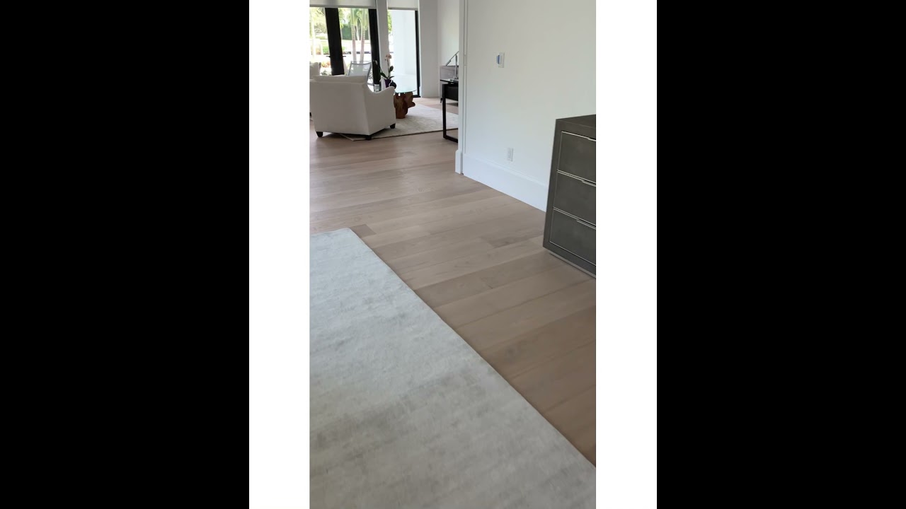 Lightly natural-toned wide plank hardwood flooring