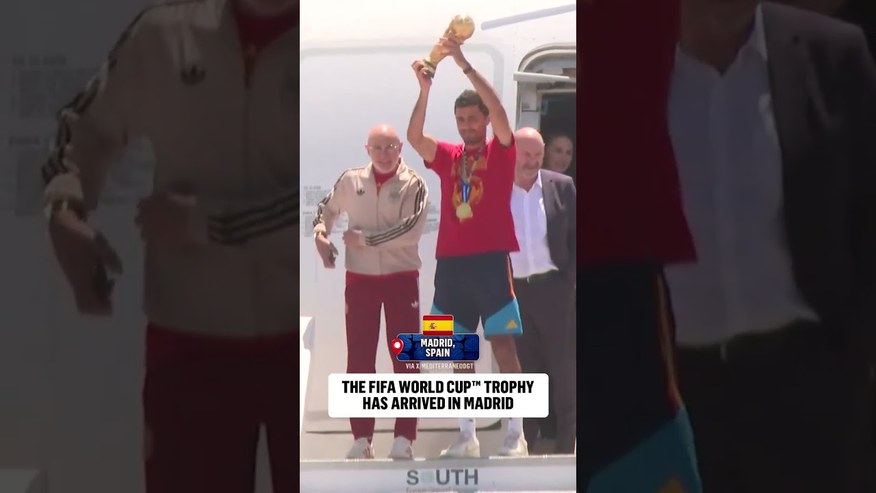 Luis de la Fuente and Captain Rodri present the FIFA World Cup trophy after arriving back in Spain