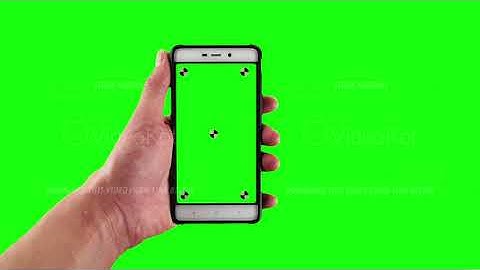 Man holds old fashioned smartphone with tracking markers on display against green screen background