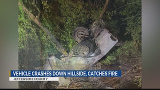 Vehicle crashes down hillside, catches fire in Jefferson County