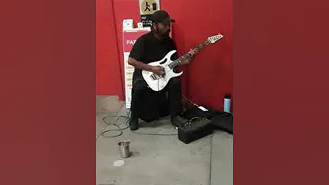Amazing street performer plays guitar like Eddie V...