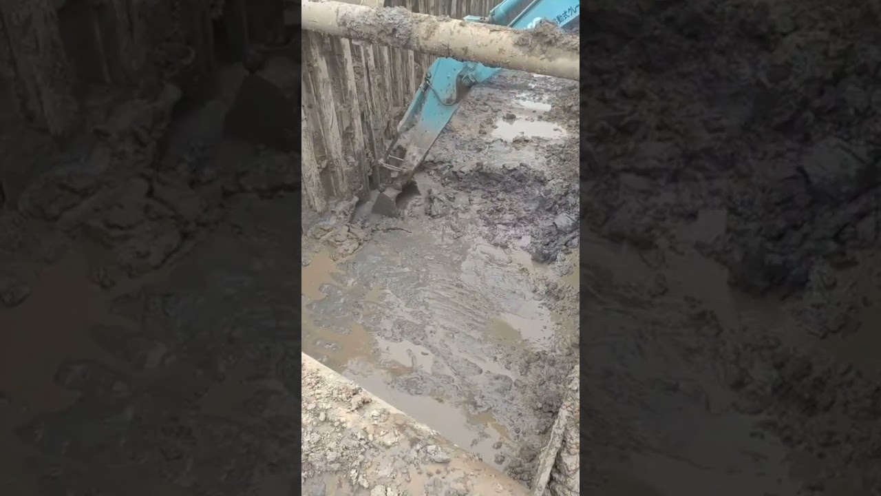 Excavator shoveling sticky ground