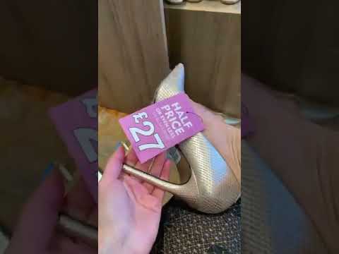 Trying on different gold and silver shoes in next