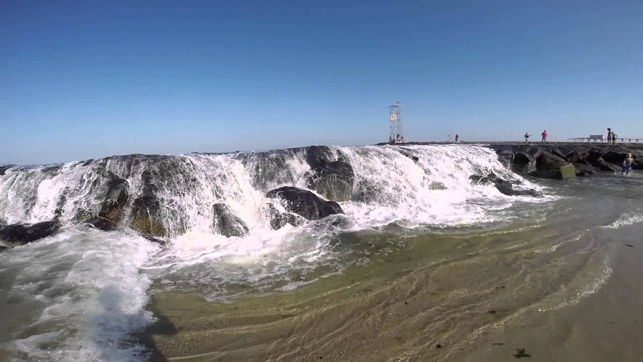 Waves Cascading Over the Jetty at Avon By The Sea as the High Tide