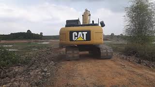 Reviewing the Little One Cat320D2 carrying logs to help the middle brother Cat320C stuck in the m...