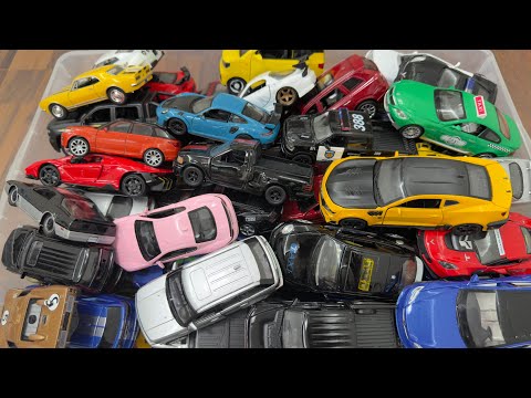 Box full of diecast model cars new and old models