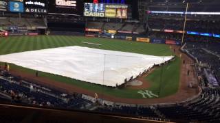 The yankee stadium grounds crew covers infield with a tarp during
light rain in fourth inning of friday night's yankees-tampa bay rays
game.