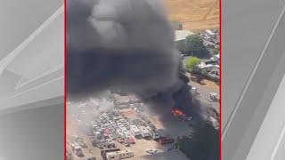 Emergency crews try to put out fire at auto yard in Rancho Cordova