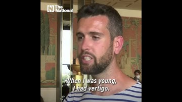 French daredevil walks a 70-metre high slackline from the Eiffel Tower