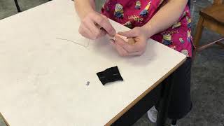 Sewing an led onto fabric with a wire thread
