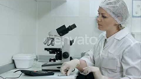 Scientist Working with Microscope Calculating and Taking | Stock Footage - Envato elements