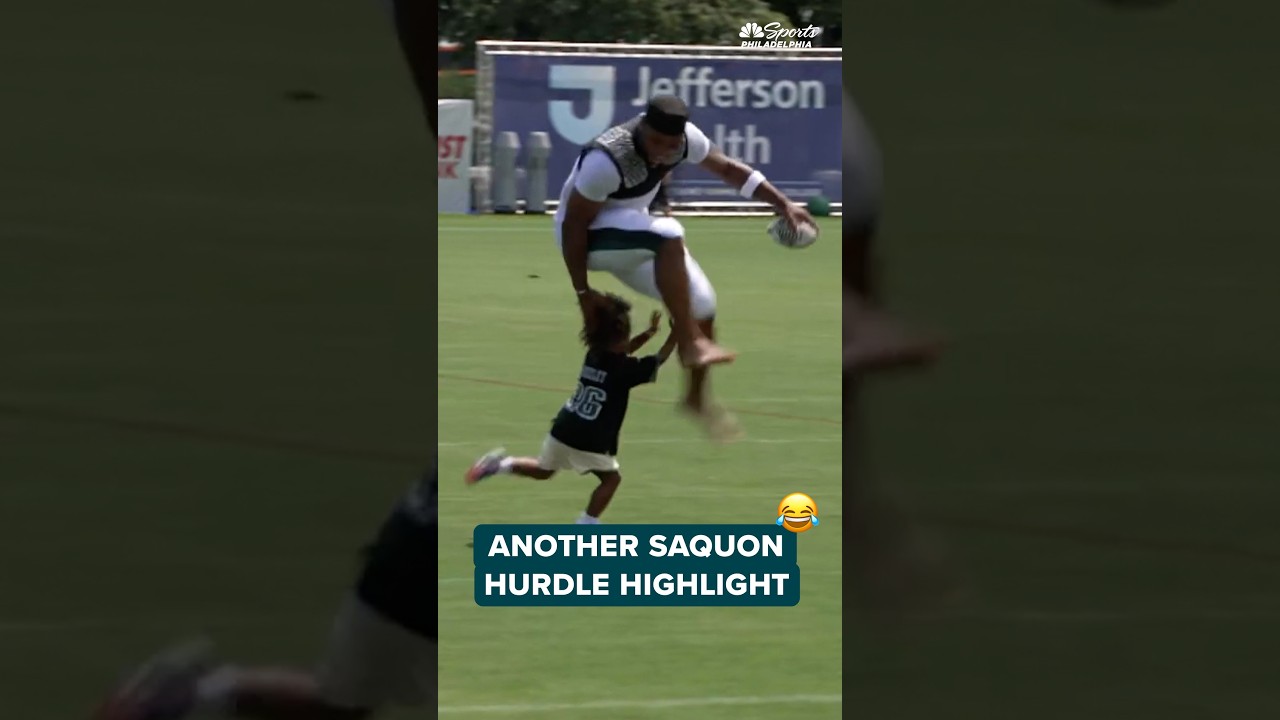 Saquon Barkley hurdles his son at Eagles training camp on Tuesday