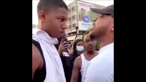Protestor gives a deep speech to a young man