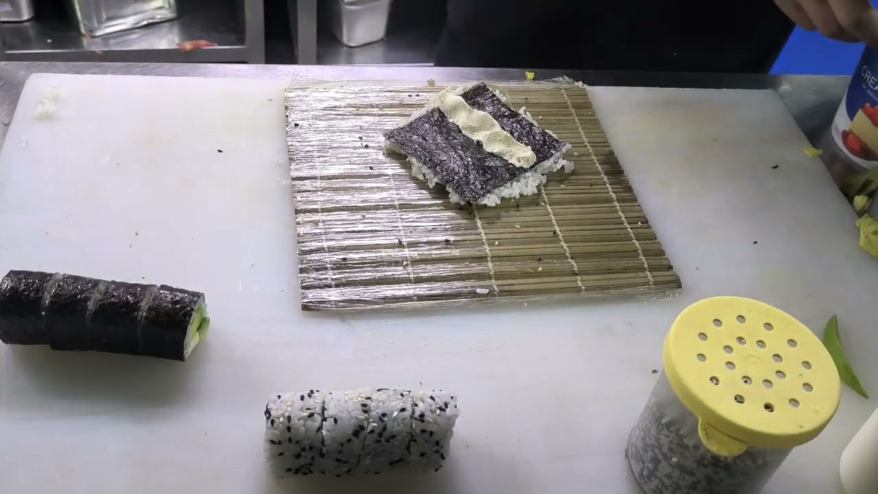 Sushi is being made at the Sushi Training Center. You can also learn by watching.
