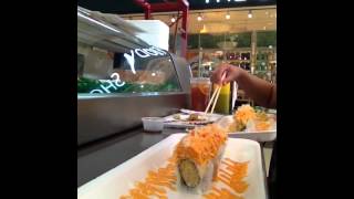 Eating sushi in the mall.