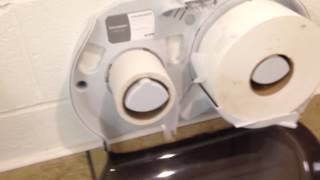 Installing a lock on the toilet paper dispenser.