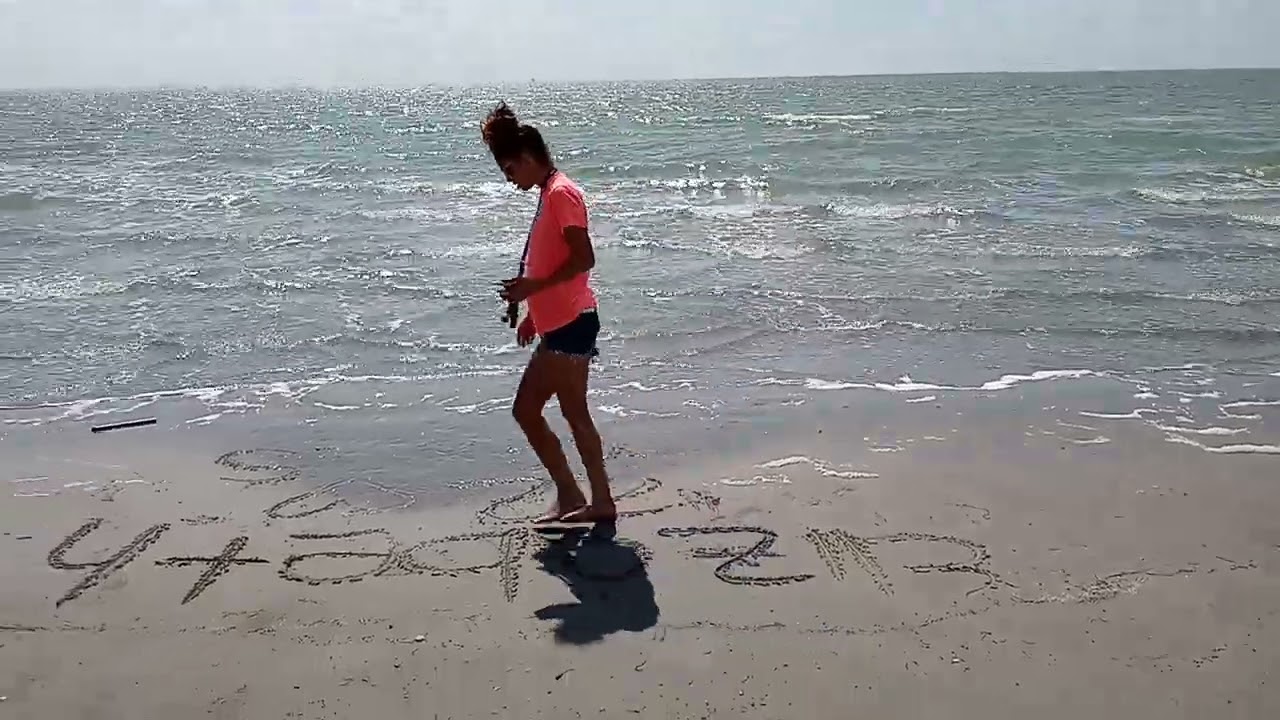 Elizabeth In Corpus Christi writing in the sand