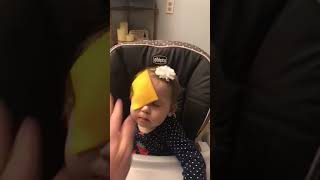 Guy throws American cheese at little girl seated in high chair